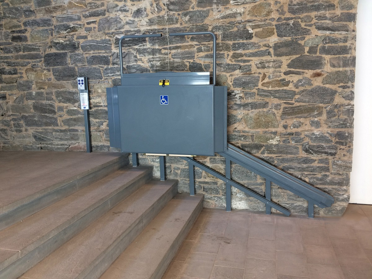 Custom RAL color XpressII Inclined Platform Lift folded at upper landing